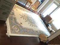 Full view of rectangular area rug displayed on hardwood floor with surrounding furniture