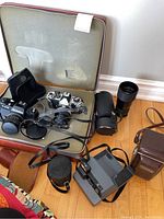 Overall view of cameras, lenses, cases in zip‐top case