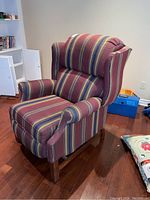 Front right three-quarter view showing upholstery, arm and leg details