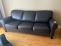 Front view of entire sofa showing three seats and armrests