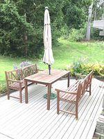 Table and two benches with umbrella set up on deck