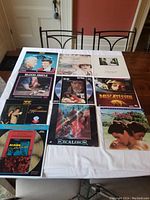 Photo of 10 LaserDiscs from the lot spread out on a white table including Blood Simple, Delicatessen, Excalibur, Alsino and the Condor, and others.