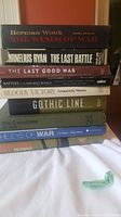 Stack of 9 war history books shown upright, titles visible on spines
