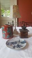 Full lot shown on white tablecloth including ginger jar, coffee grinder, lamp, and collector plate