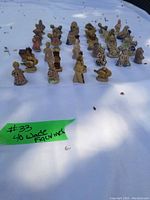 Wide photo showing all 40 Wade figurines arranged in rows on a white surface