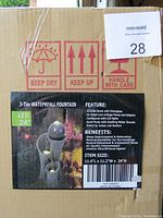 Box photo showing product label and features including durable resin with fiberglass, low-voltage pump, LED lights, quiet pump, and size details.