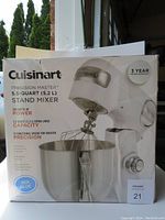 Front view of the Cuisinart Precision Master 5.5-Quart Stand Mixer box showing key features such as 5.5 quart capacity, 500 watts of power, and 12 functional speeds. The box lists the color as sea blue.