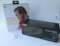 Even H4 Glasses for Your Ears headphones box and Escape wireless stereo speaker box side-by-side on white background.