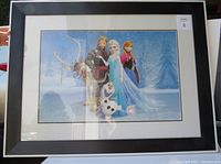 Front photo of framed Frozen themed print art showing key characters and winter scene