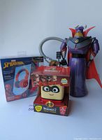 Photo showing Spiderman headphones in box, Toy Story Villain Robot figure, and Incredibles 2 boxed toy