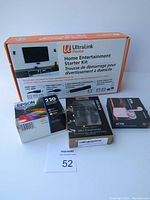 Photo showing the Ultralink Home Entertainment Starter Kit box, Epson 220 ink cartridge, Escape Mini Earbuds, and iConnects Pink Earbuds in original packaging.