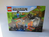 Front view of Minecraft LEGO set box showing "The Abandoned Mine" set with 248 pieces, recommended for ages 7+.