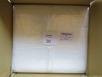 View of packaged clear poly bags stacked inside the box.