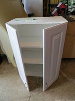 White hanging cabinet with two paneled doors and adjustable shelves inside.