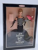 Full front view of the boxed Barbie doll displaying the figure and packaging with anniversary title.