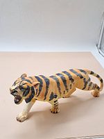 Side view of the vintage molded tiger ornament showing walking pose and detailed painting