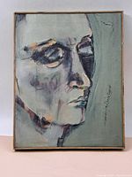 Frontal view of the oil on canvas portrait showing side profile of a person's face in muted colors with simple wooden frame.