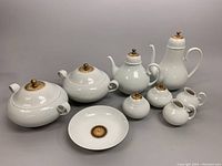 All nine porcelain pieces displayed on grey background