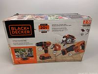Original packaging box of Black & Decker 4-Tool Combo Kit featuring drill/driver, circular saw, reciprocating saw, and LED light. Box shows product branding, features, and condition.