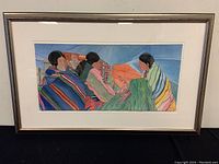 Full view of framed watercolor painting under glass in metallic wood frame