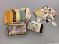 Overall view of boxes and envelopes containing assorted vintage stamps