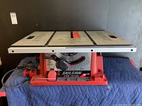 Front view of Skilsaw 10 inch blade table saw with visible work surface and blade adjuster.