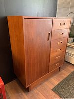 Front left angle view showing overall form, drawer layout and cabinet door