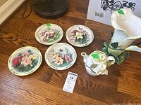 Four Bradford Exchange floral ceramic collector plates including close-up view
