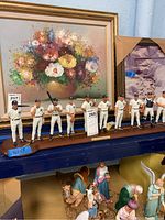 All seven figures on wood base, front view