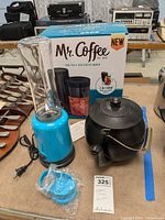 Blue Yes Chef personal blender next to black McCoy teapot with metal handle. Mr. Coffee box behind showing iced tea and iced coffee maker.