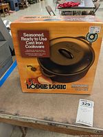 Front view of the boxed Lodge Logic 5 Quart Dutch Oven showing product branding and packaging details.