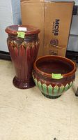 Full view of ceramic planter pot and tall stand showing matching green and brown glazed design.