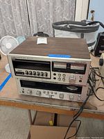 Front view of stacked cassette deck and receiver showing faceplates and knobs