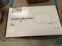 Original box of Cooau CU-121 portable video player showing product name, feature of swivel screen, and rechargeable battery.