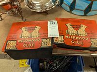 Two closed boxes of Weldwood Plastic Resin Glue with vintage packaging and branding visible.