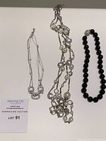 All three necklaces displayed flat on a white background showing overall length and design.