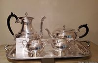 Overall image showing all five pieces of the vintage silver plated tea service on the ornate serving tray.