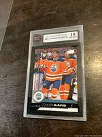 Front view of graded Connor McDavid hockey card in PSA slab, showing 10 Gem Mint grade and image of player in Oilers jersey