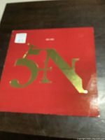 Red album cover with gold 5 1 N lettering logo visible, front of sleeve showing wear.