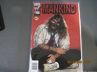 Front cover of WWF Chaos! Mankind comic first issue showing autograph and character with mask on red background.