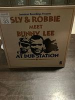 Front cover of the vinyl LP album titled 'Sly & Robbie Meet Bunny Lee At Dub Station' showing artwork and title text.