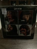 Front cover of The Beatles 'Let It Be' album showing four band member portraits and album title.