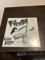 Front cover of The Fiends Grave Digger vinyl LP album showing illustrated woman and title.