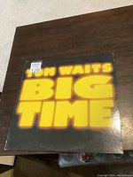 Front cover of the Tom Waits Big Time vinyl LP showing bold yellow text on black background.