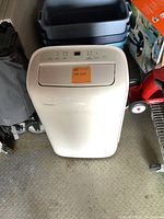 Front view of one Toshiba branded portable floor air conditioning unit with a control panel on top and a sticky note labeled '193 AC Unit'