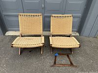Front view of two Japanese rattan chairs with one chair's frame detached and placed forward on the ground.