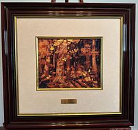 Framed image of the artwork showing the wide dark wood frame with white mat and gold inner lining with the mounted lithograph of the forest scene.