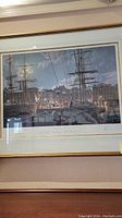 Overall view of framed John Stobart limited edition print showing ships at harbor scene