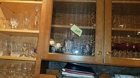Upper cabinets with clear glasses in various sizes and styles