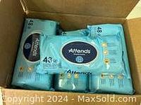 Box containing six packs of Attends washcloths, each pack with 48 wipes, packaged in light blue wrapping with Attends logo.